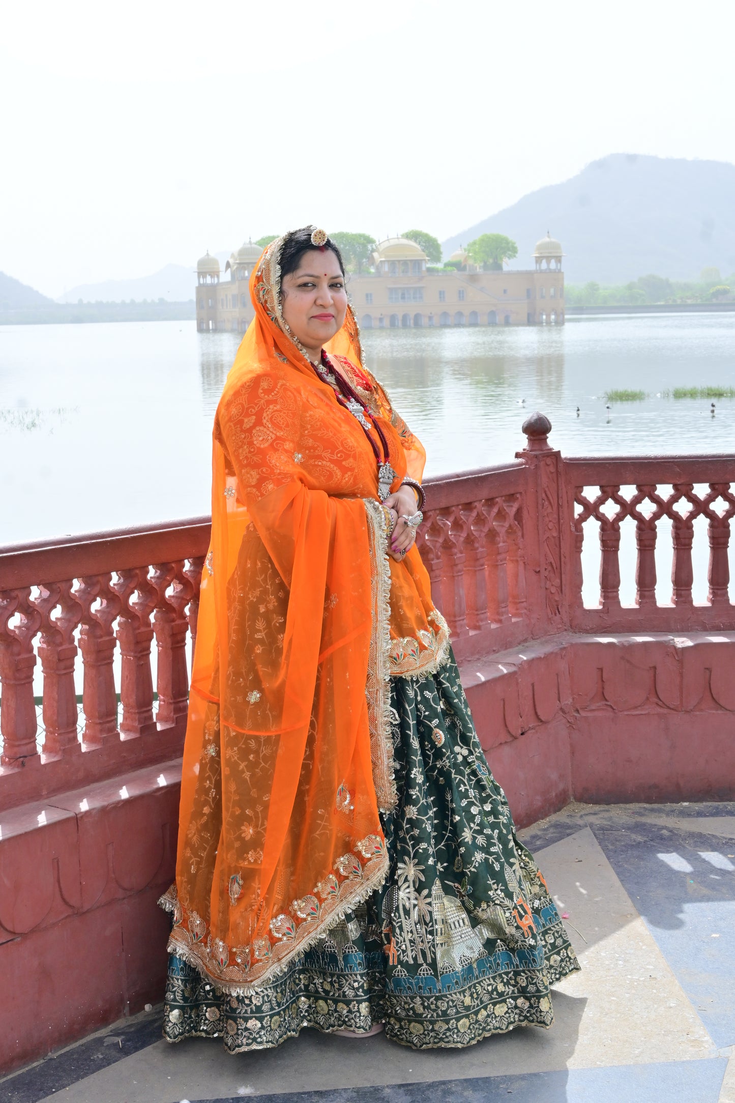 Green Lehenga with Orange Odhani & Heritage Embroidery